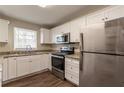 The kitchen features stainless steel appliances, granite counters, and white cabinets at 2062 Whites Mill Rd, Decatur, GA 30032