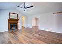 Bright living room features vaulted ceilings, a brick fireplace, and wood flooring at 2228 Arbor Forest Sw Trl, Marietta, GA 30064