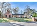 Classic brick home with a lush front yard and mature trees offering curb appeal and charm at 3189 Terramar Dr, Atlanta, GA 30341