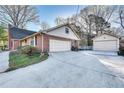 Spacious driveway leading to a two car garage and separate storage shed at 3189 Terramar Dr, Atlanta, GA 30341
