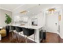 Open kitchen design with a bar, modern appliances, and stylish pendant lighting, ideal for social gatherings at 130 26Th Nw St # 807, Atlanta, GA 30309