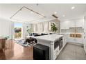 Open concept kitchen showcasing stainless appliances, an island with seating, and seamless flow to the living area at 130 26Th Nw St # 807, Atlanta, GA 30309