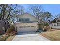 New construction home featuring a two-car garage and stylish brick and siding exterior at 1604 Temple Ave, Atlanta, GA 30337