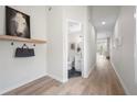 Bright hallway featuring modern light fixtures, wood floors, and a conveniently located powder room at 1604 Temple Ave, Atlanta, GA 30337