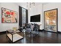 Stylish living room features modern art, a sleek TV, and comfortable seating, ideal for entertaining or unwinding at 206 11Th Ne St # 205, Atlanta, GA 30309