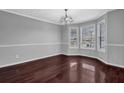 Spacious dining room features hardwood floors, chair rail, and ample natural light at 617 Creekstone Ct, Jonesboro, GA 30236