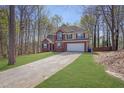 Traditional two-story brick home featuring a driveway leading to an attached two-car garage at 617 Creekstone Ct, Jonesboro, GA 30236