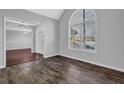 Bright living room boasts neutral walls, arched window, and updated floors at 617 Creekstone Ct, Jonesboro, GA 30236