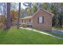 Charming brick and siding home with a well-maintained front yard and covered porch at 8633 Hilltop Rd, Jonesboro, GA 30236