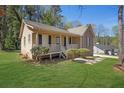 Cozy home with a welcoming front porch, lush lawn, and mixed siding at 8633 Hilltop Rd, Jonesboro, GA 30236