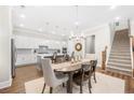 Dining area features a staircase, wood floors, and seamless flow into the gourmet kitchen at 1929 Finnish Ln, Kennesaw, GA 30152