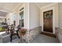 Inviting front porch with seating area, decorative brick accents, and a welcoming wreath on the front door at 1929 Finnish Ln, Kennesaw, GA 30152