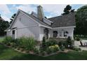 Beautiful home featuring white siding, stone accents, covered patio, and well-maintained lawn, offering a serene outdoor space at 237 Barbara Sw Ln, Mableton, GA 30126