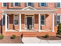 Close-up of an inviting front porch featuring brickwork, white columns, and manicured landscaping at 2517 Hampton Park Ct, Marietta, GA 30062