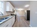 Updated kitchen featuring stainless steel appliances and granite countertops overlooking an adjacent dining area at 2628 Miriam Ln, Decatur, GA 30032