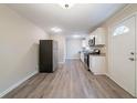 A well lit kitchen featuring stainless steel appliances, granite countertops, and durable laminate flooring at 2628 Miriam Ln, Decatur, GA 30032