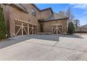 View of the three-car garage with decorative doors and a spacious driveway at 2814 Adams Oaks Ln, Marietta, GA 30062