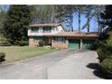 Charming brick home with a two-car garage and a long driveway at 3274 Jodeco Pl, Jonesboro, GA 30236