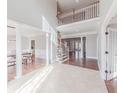Grand foyer with high ceilings, staircase, and elegant tile flooring leading to dining and living areas at 9175 Etching Overlook, Johns Creek, GA 30097