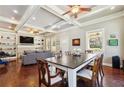 Open-concept living and dining room featuring hardwood floors, coffered ceiling, and a built-in bookcase at 1503 Westwood Sw Ave, Atlanta, GA 30310