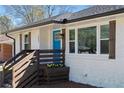 Charming exterior with a bright blue door, white brick, wood shutters, and a flower box at 1882 Rosewood Rd, Decatur, GA 30032