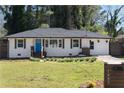 Well-maintained front exterior with a blue door, manicured lawn, and fresh landscaping at 1882 Rosewood Rd, Decatur, GA 30032