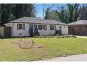 Beautifully landscaped front yard of white brick home with charming curb appeal at 1882 Rosewood Rd, Decatur, GA 30032