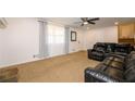 Inviting living room featuring plush carpet, a ceiling fan, and a comfortable leather sectional sofa at 4130 N Quail Dr, Douglasville, GA 30135