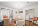 Bright living room with statement lighting, modern chairs, and a convenient laundry closet at 1893 Windsor Sw Dr, Atlanta, GA 30311