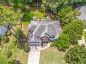 Aerial view of home featuring deck with outdoor seating, firepit, mature trees and well-kept lawn at 119 Creekside Vw, Hiram, GA 30141
