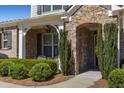 Close-up view of home's stone-accented entrance featuring manicured bushes, brickwork, and arched entryway at 2564 Lulworth Ne Ln, Marietta, GA 30062