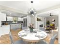Charming dining room adjacent to kitchen and living room featuring a round table and modern light fixture at 3524 Brookfield Ln, Decatur, GA 30032
