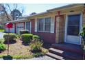 Attractive brick home featuring a well-manicured garden and a convenient four-car garage at 3528 Highway 42 S, Locust Grove, GA 30248