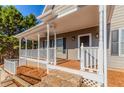 Inviting front porch features stone steps, classic columns, and ample space for relaxing and entertaining at 1019 Walnut Creek Dr, Woodstock, GA 30188