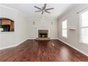 Spacious living room with hardwood floors, fireplace and large windows that provide lots of natural light at 1019 Walnut Creek Dr, Woodstock, GA 30188
