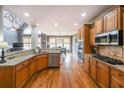 Gourmet kitchen with granite countertops, stainless steel appliances, and custom cabinetry at 103 Gold Springs Ct, Canton, GA 30114