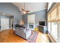 Bright living room featuring vaulted ceilings, fireplace, and large windows at 103 Gold Springs Ct, Canton, GA 30114