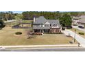 Aerial view of a two-story home with a spacious yard, a swimming pool, and mature trees at 2100 Spruce Lake Dr, Dacula, GA 30019