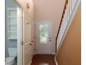 Bright entryway with decorative glass door, hardwood floors, and staircase at 2158 Berryhill Se Cir, Smyrna, GA 30082