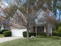 A two-story home with brick and siding exterior, lush front lawn, and a two-car garage, shaded by mature trees at 2158 Berryhill Se Cir, Smyrna, GA 30082