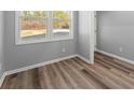 Bright bedroom featuring wood-look flooring, neutral gray walls, and a large window at 3170 Old Hwy 92 Dr, Acworth, GA 30102