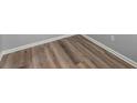 Close up of wood-look flooring, neutral gray walls, and bright white trim at 3170 Old Hwy 92 Dr, Acworth, GA 30102