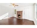 Bright living room features new floors, white walls, fireplace with brick surround, and abundant natural light at 5520 Glore Sw Dr, Mableton, GA 30126