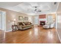 Spacious living room with a cozy fireplace, hardwood floors, and coffered ceiling at 115 Dearing Woods Way, Covington, GA 30014