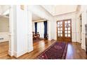 Spacious foyer featuring hardwood floors, white trim, and dining area at 5352 Lacosta Ln, Alpharetta, GA 30022