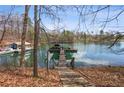 Waterfront property features a private dock with covered boat storage and easy access to the open water at 6535 Smith Cove Way, Cumming, GA 30041