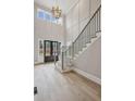 Grand foyer with soaring ceilings, hardwood floors, and a staircase with a modern railing at 2583 Apple Valley Rd, Brookhaven, GA 30319