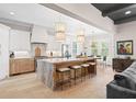 Gourmet kitchen boasts a large marble island, modern lighting, and stainless steel appliances at 2583 Apple Valley Rd, Brookhaven, GA 30319
