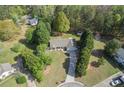 Aerial view of a well-maintained home with mature trees on a verdant lot, showcasing its serene setting at 313 Ridge Hill Cir, Canton, GA 30115