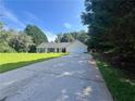 Inviting single-story home featuring a long driveway and lush green lawn at 313 Ridge Hill Cir, Canton, GA 30115